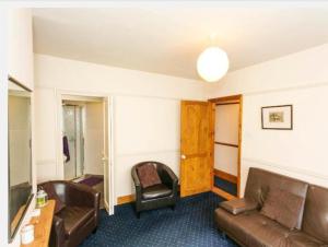 a living room with a couch and a chair at Fishermen Cottage - 5 star location- 90sq garden -2 living room- 2 bath room -pets friendly -comfortably sleep 5-6 people -50 percent off monthly -self check in in Deal +12 photos