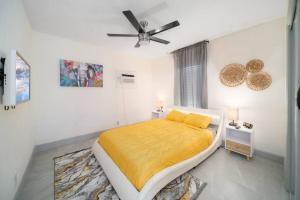 a bedroom with a bed and a ceiling fan at Mango Lovers Zen Beach Retreat w Hot Tub in Fort Lauderdale