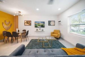 a living room with a couch and a table at Mango Lovers Zen Beach Retreat w Hot Tub in Fort Lauderdale