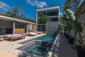 a swimming pool in the backyard of a house at Beautifully Designed 3-BR Escape Close to Downtown in Tulum