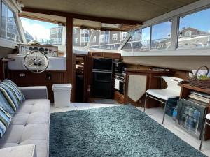 a living room with a couch and a kitchen on a yacht at Private Yacht in San Francisco in San Francisco