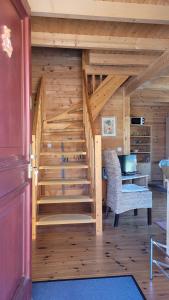 a wooden staircase in a room with a desk at Ferienhaus Bliev-Hee Nr 2 in Klink