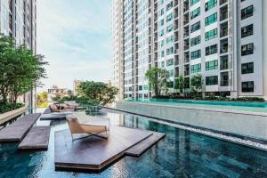 a swimming pool in a city with buildings at Sea View 2 Bed Room Condo @ Central Pattaya in Pattaya Central