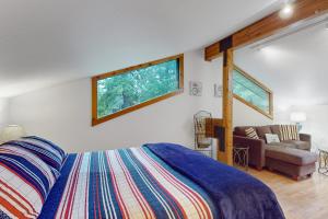 a bedroom with a bed and a couch at St. Moritz House & Apartment in Girdwood