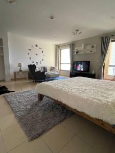 a bedroom with a bed and a living room at Sunset Oasis: Beachfront Studio in Dubai +11 photos