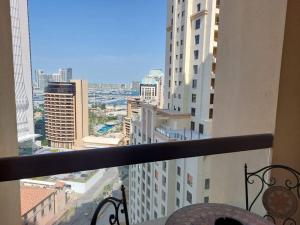 a view of a city from a balcony of a building at Sunset Oasis: Beachfront Studio in Dubai