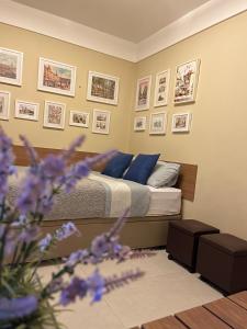 a bedroom with a bed with blue pillows and pictures on the wall at Rio de Janeiro Botafogo Zona Sul in Rio de Janeiro