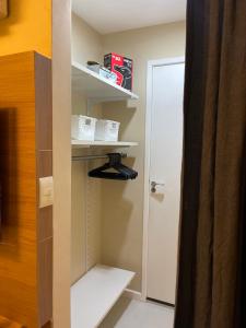 a room with a closet with shelves and a door at Rio de Janeiro Botafogo Zona Sul in Rio de Janeiro