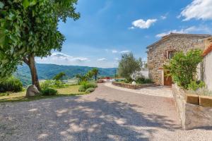 a stone house with a view of the mountains at Sussini in Potpićan