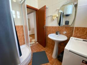 a bathroom with a sink and a toilet and a shower at Alina's apartment in Bečići +72 photos