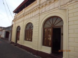 a building with arched doors on the side of a street at Beatrice House Galle Fort in Galle