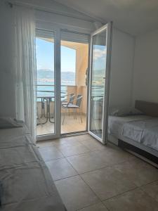 una camera con letto e un balcone con tavolo di Apartments Toni a Trogir