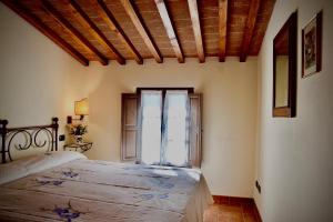 a bedroom with a bed and a large window at Relax in Chianti IL BORGO 8 in Montespertoli +11 photos