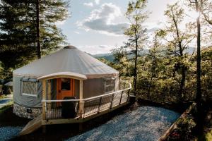 a yurt in the middle of a forest at Junaluska @ Sky Ridge Yurts in Bryson City