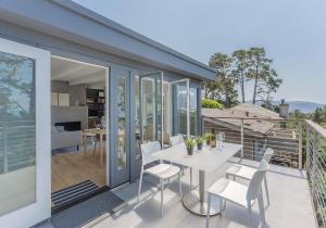 a white dining table and chairs on a balcony at 3904 Out of the Blue home in Carmel