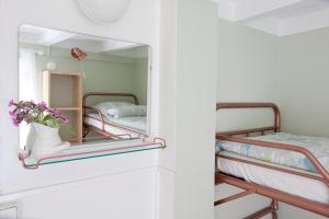 a room with two bunk beds and a mirror at Soltorp Eco Lodge in Porvoo