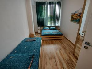 a room with two beds and a window at VasylOk in Warsaw