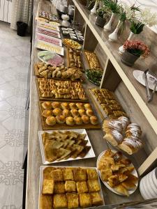 a buffet line with different types of pastries and breads at FIRDAVS HOTEL in Navoi