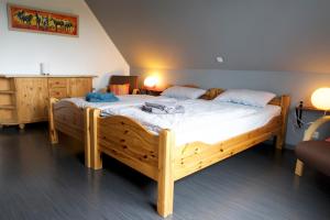 a bedroom with a wooden bed in a room at FeWo Birkenweg in Schneverdingen