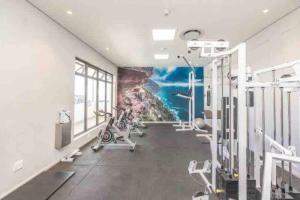 a room with a gym with a painting on the wall at Mountain View Apartment at Woodstock Quarter in Cape Town