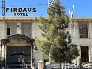 a man standing in front of a hotel at FIRDAVS HOTEL in Navoi