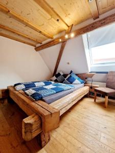 a bedroom with a wooden bed in a attic at Wood & Stone Lodge 3 in Donaueschingen