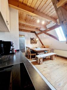 a kitchen and dining room with a table in a room at Wood & Stone Lodge 3 in Donaueschingen