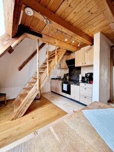 a kitchen with a wooden staircase in a room at Wood & Stone Lodge 3 in Donaueschingen