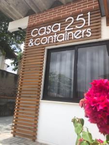 a sign on the side of a building with pink flowers at Casa 251 in Pomerode