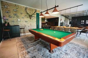 a pool table in the middle of a room at Magdala Lodge - wellness oasis in Donja Pušća