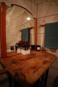 a wooden table with two plants on it in a bathroom at The Serenity House in Nar