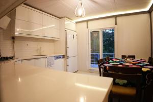 a kitchen with a table and a dining room at The Serenity House in Nar