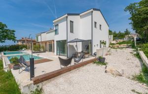 a home with a swimming pool and a house at Green Zebra in Fuškulin