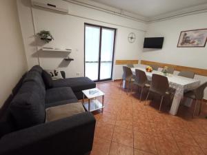 a living room with a couch and a table and chairs at Apartment Feruco in Kršan
