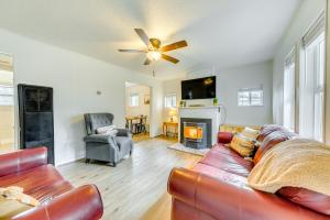 a living room with a couch and a fireplace at Cloudcroft Vacation Rental about 1 Mi to Downtown! in Cloudcroft