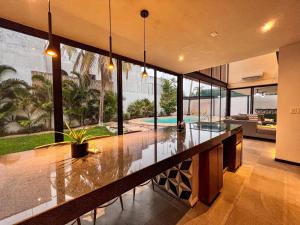 an open kitchen with a large island in a house at Casa Concordia in Mérida