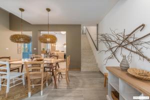 a dining room and kitchen with a table and chairs at Provence in Vilanija