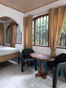 a room with a bed and a table and chairs at Cabinas carol in Pavones