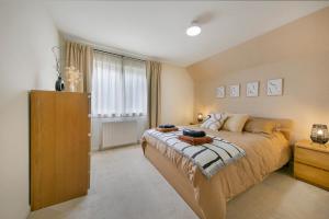 a bedroom with a large bed and a window at Links Road Apartment ✪ Grampian Lettings Ltd in Aberdeen