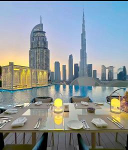 a dining table with a view of a city skyline at Burj Khalifa Downtown Fountain in Dubai