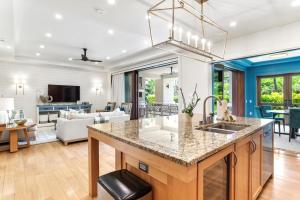 an open kitchen and living room with a large island at K B M Resorts Montage Residence Pama 2206 Stunning Groundfloor 3 bed Perfect for Families Easy pool access LOccitane Amenities in Kapalua