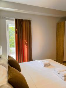 sypialnia z dużym białym łóżkiem i oknem w obiekcie Solea Hotel we Wlorze