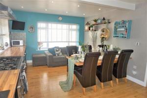 a kitchen and living room with a table and chairs at Lavender House, Fleet in Fleet