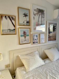 a bedroom with pictures on the wall above a bed at Apartment with beautiful ocean view in Costa Del Silencio