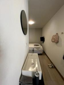 baño con lavabo y 1 cama en una habitación en Nina´s - Juan Santamaria, en Alajuela