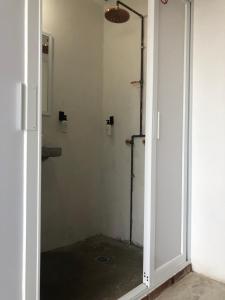 an open door to a bathroom with a shower at Hotel RHV in Zihuatanejo