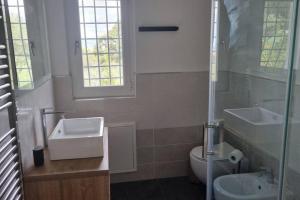 a bathroom with a sink and a toilet and a window at Villetta con giardino in Genova +24 photos