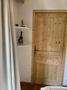 a room with a wooden door and a curtain at Mont Blanc 25, vue Mont blanc, balcon, parking in Chamonix-Mont-Blanc