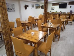 an empty restaurant with wooden tables and chairs at Reydel Hotel in Istanbul