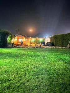 a man standing in a field at night at Sahure Pyramid View lnn in Cairo